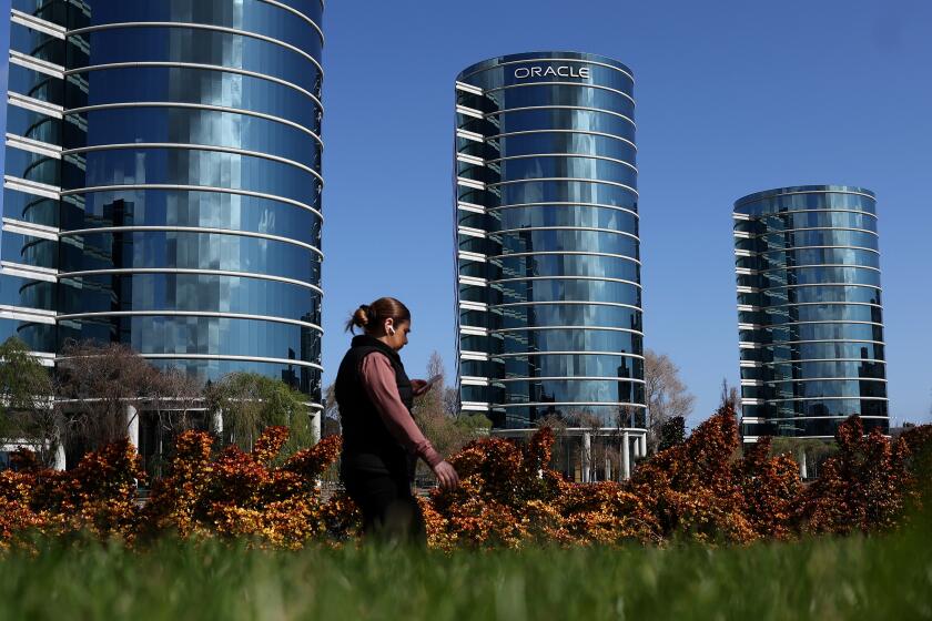 REDWOOD SHORES, CALIFORNIA - MARCH 11: A pedestrian walks by Oracle headquarters on March 11, 2024 in Redwood Shores, California. Oracle will report third quarter earnings today after the closing bell. (Photo by Justin Sullivan/Getty Images)