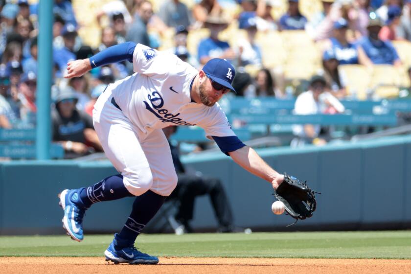LOS ANGELES, CA MAY 8, 2024 - Dodgers third baseman Max Muncy fields the ball but is too late to throw out Marlins batter Jake Burger for a base hit in the fourth inning of the Los Angeles Dodgers baseball game against the Miami Marlins Wednesday, May 8, 2024, in Los Angeles. (Wally Skalij / Los Angeles Times)