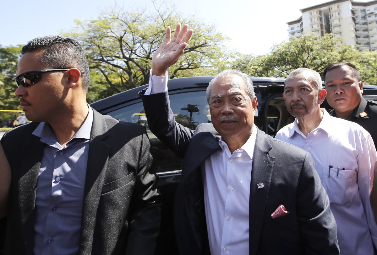 Former Malaysian Prime Minister Muhyiddin Yassin waving