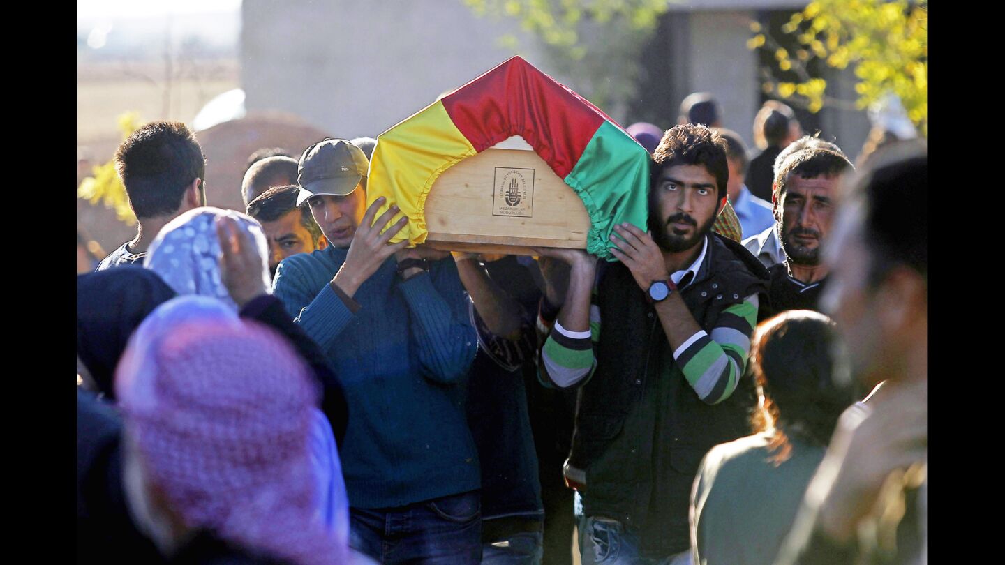 Mourners carry the coffin of a Kurdish fighter killed in the battle with Islamic State militants in Kobani, Syria, during a funeral Oct. 21 in Suruc, Turkey, just across the border.