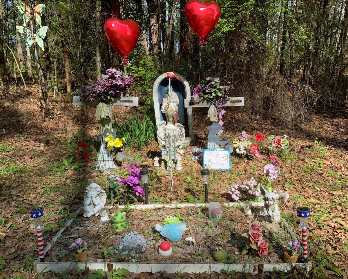 A memorial to two Alabama teenagers killed in 1999 stands beside a road at Ozark, Ala., on Tuesday, March 19, 2019. A woman who fueled a social media frenzy with claims about police being involved in the killings of two Alabama teens found dead in a car trunk in 1999 testified that she was lying the whole time. Rena Crumb, 53, recanted her allegations Thursday, Aug. 4, 2022 during a hearing for an Alabama trucker awaiting trial on capital murder charges in the slayings of J.B. Beasley and Tracie Hawlett, WTVY-TV reported. (AP Photo/Kim Chandler)