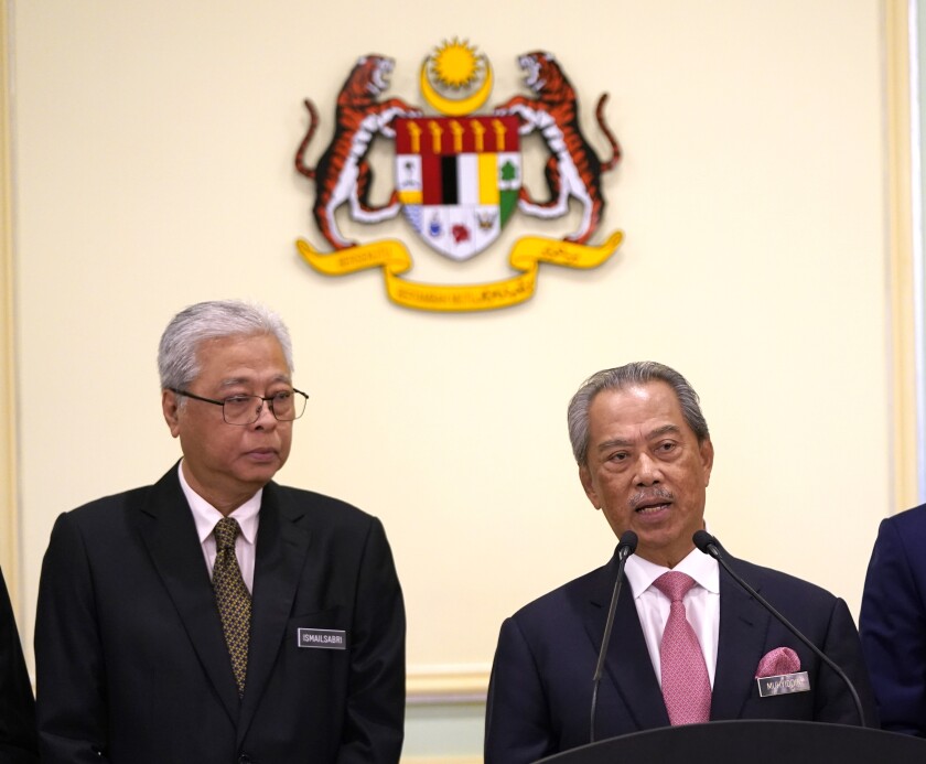In this Wednesday, May 11, 2020, photo, Malaysia's Prime Minister Muhyiddin Yassin, right, and Defense Minister Ismail Sabri Yaakob attend a press conference in the Prime Minister's office in Putrajaya, Malaysia. Muhyiddin has appointed Ismail as his deputy, in a calculated bid to dissuade the party from withdrawing support for his leadership. (AP Photo/Vincent Thian)