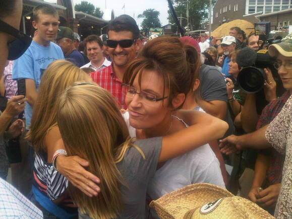 Palin hugs a fairgoer as she makes the rounds of the State Fair Friday.