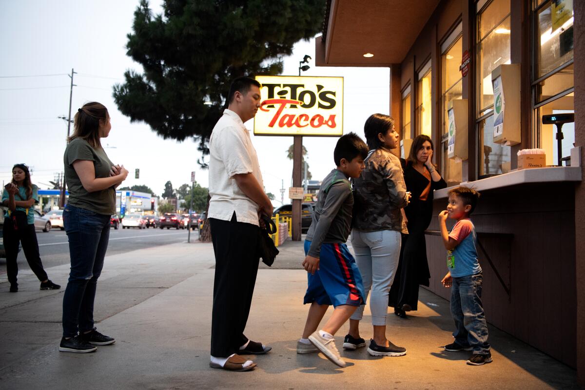 Customers line up to order at Tito's Tacos on Monday, July 15, 2019