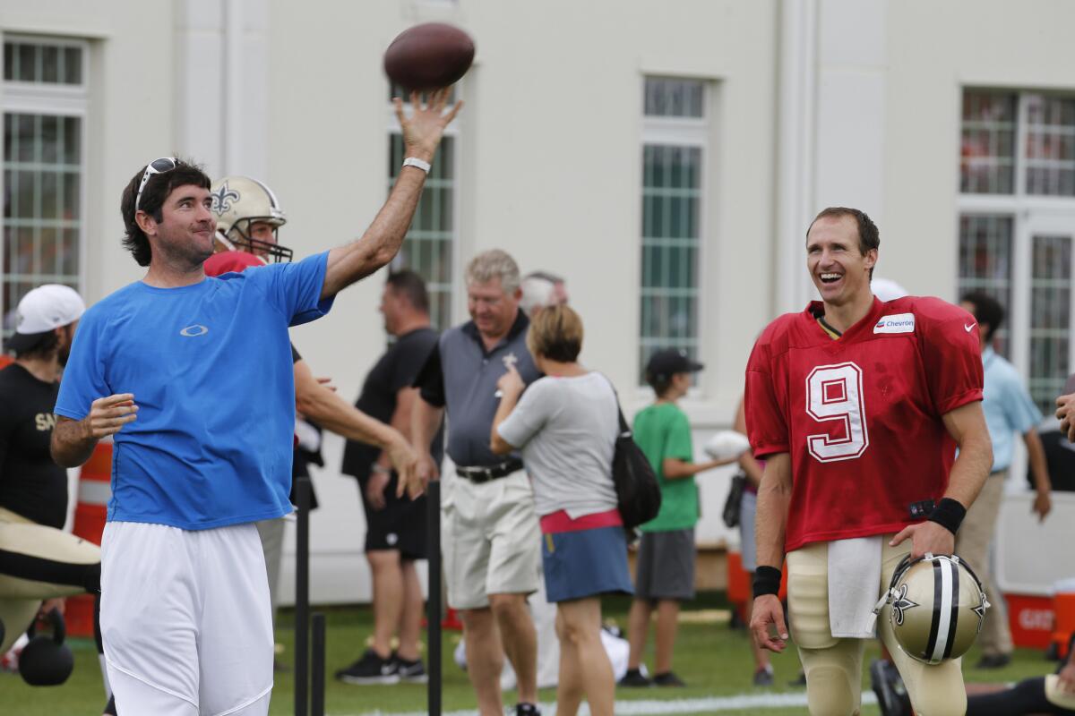 New Orleans Saints quarterback Drew Brees (9) watches pro golfer Bubba Watson throw a football after a joint practice between the New England Patriots and the Saints on Aug. 20.