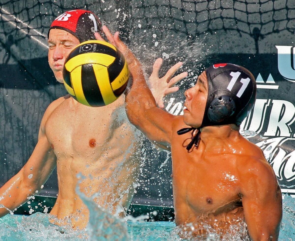 Burroughs High goalie Dillon Wiegand, left, and Oscar Hernandez team up to block a shot in a 13-4 win over Monrovia.