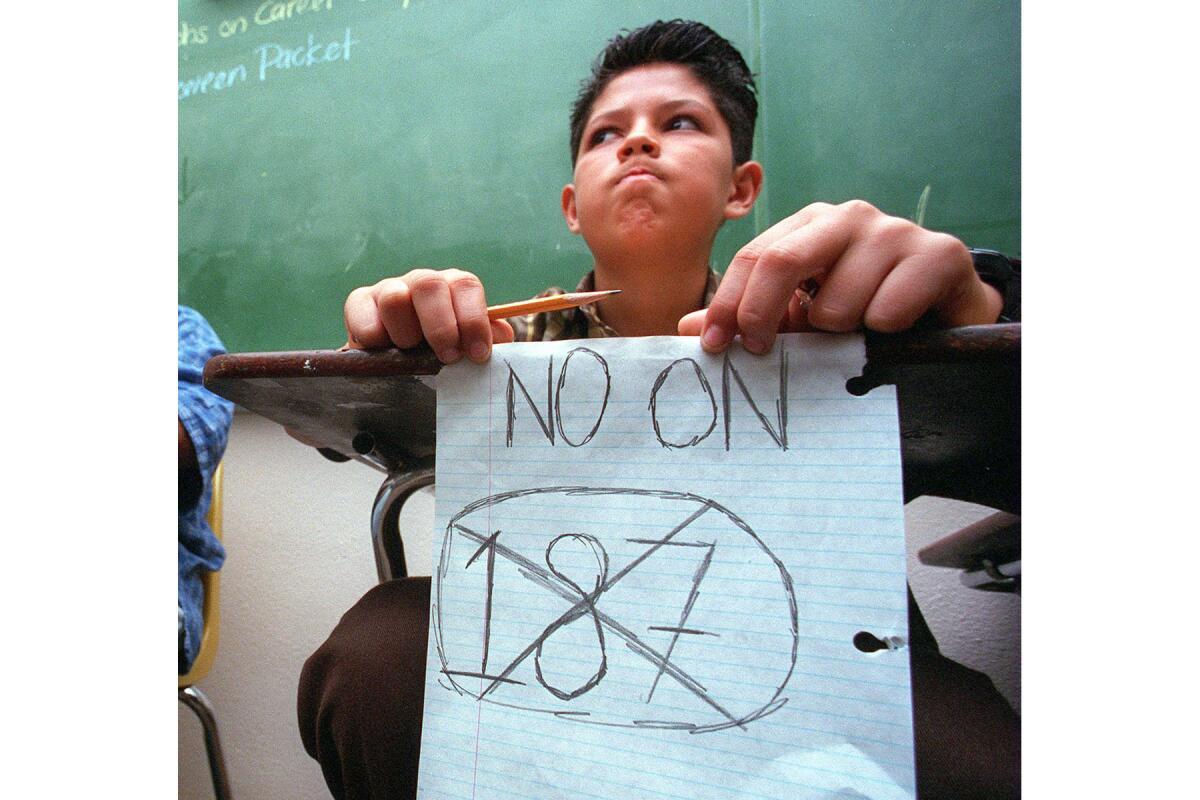 Nov. 4, 1994: Eighth-grader Raul Altamirano shows his opinion during debate on Proposition 187 at Lennox Middle School in Lennox.