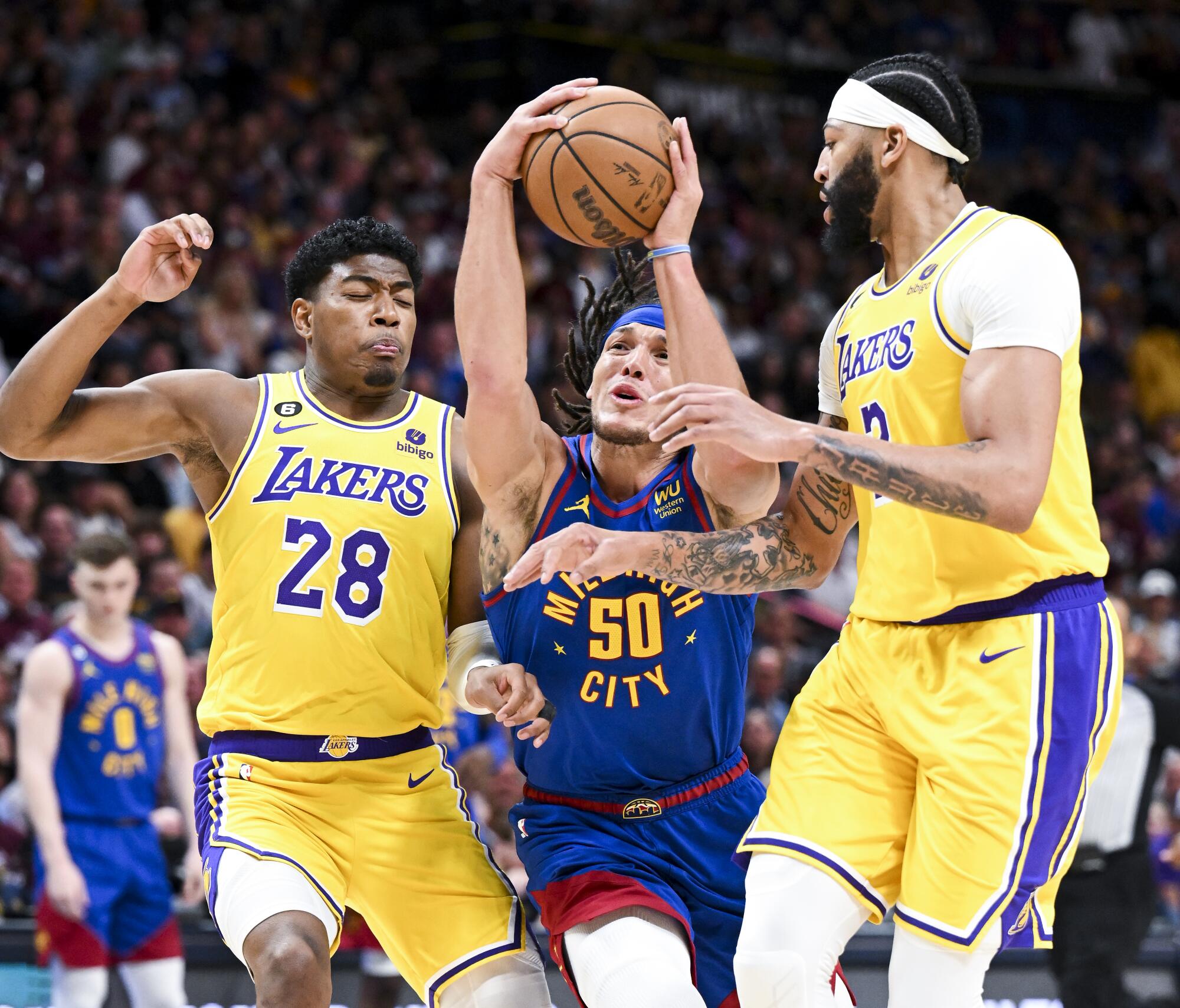 Nuggets forward Aaron Gordon drives to the basket between Lakers forward Rui Hachimura and forward Anthony Davis