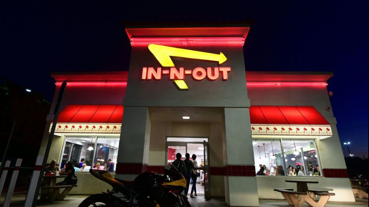 Patrons enter an In-N-Out Burger in Alhambra on Aug. 30. California's Democratic Party Chairman Eric Bauman called for a boycott of the Irvine-based fast food chain after it donated $25,000 to help California Republicans in November. He later walked back the boycott.