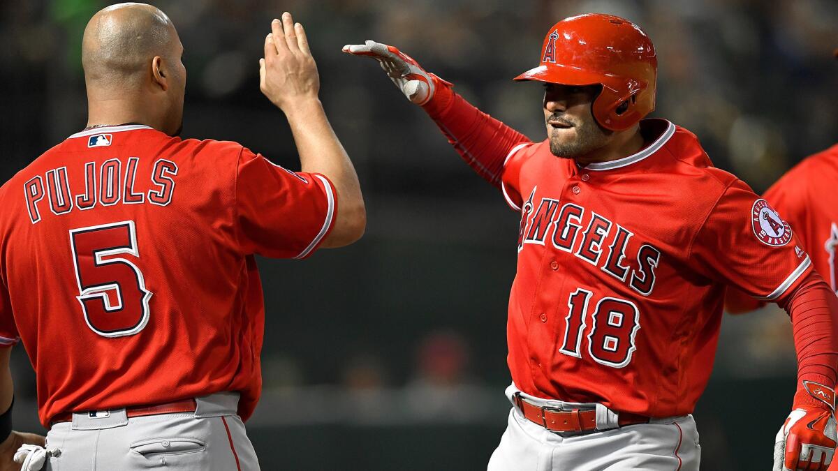 Angels catcher Geovany Soto (18) is congratulated by teammate Albert Pujols after hitting what proved to be game-winning, two-run home run against the A's in the ninth inning Tuesday.