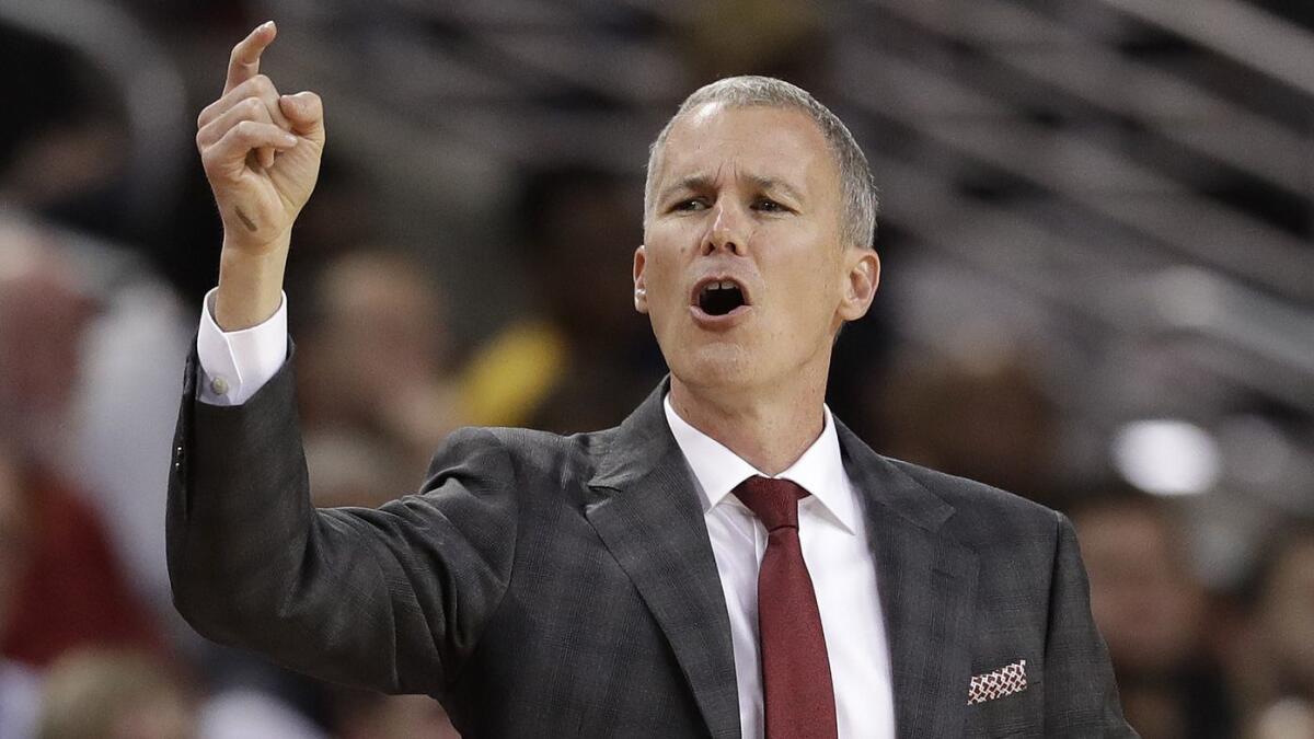 USC head coach Andy Enfield yells out instructions from the bench during the first half against Nevada.