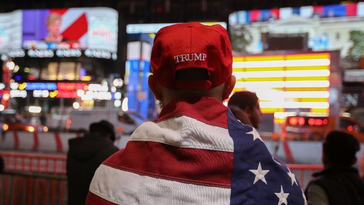 A Donald Trump supporter watches the screens outside Times Square Studios as he awaits the results of the U.S. presidental election on November 9, 2016 in New York City.