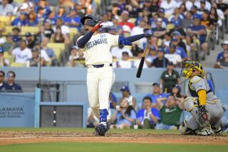 Los Angeles Dodgers' Miguel Vargas, left, hits a solo home run as Milwaukee Brewers.