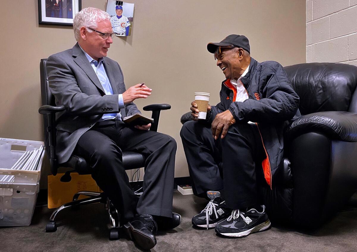 Sportswriter John Shea speaks with Hall of Famer Willie Mays during an interview in the San Francisco Giants clubhouse at Oracle Park.