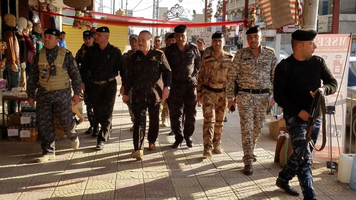 Mosul police Chief Wathaq Hamdani, center, toured east Mosul's Zahour neighborhood Wednesday, an area where Islamic State militants still lurk months after it was freed.