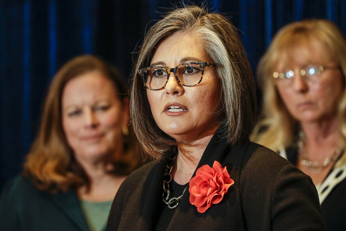 A woman with glasses in businesswear speaking