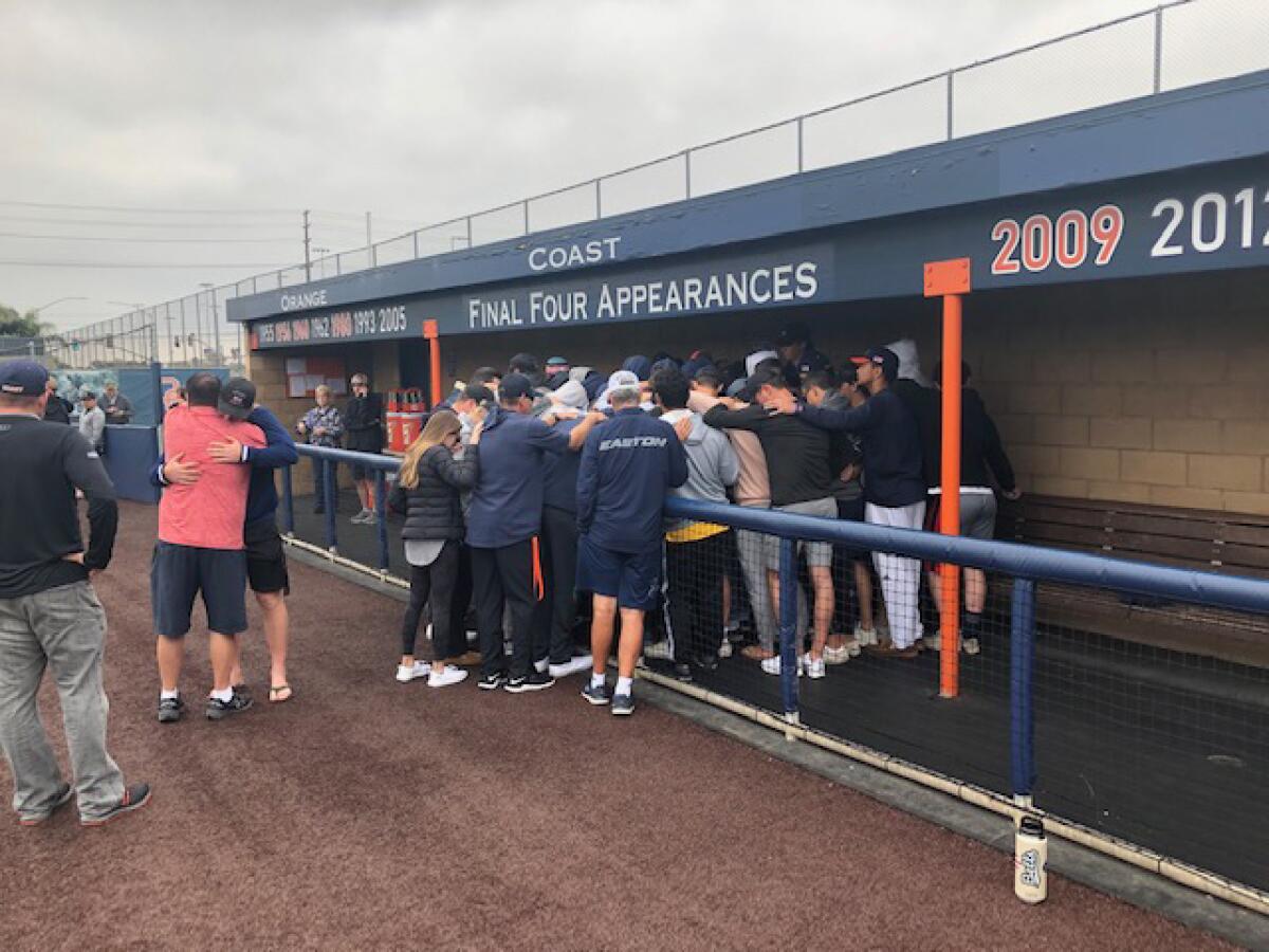 Orange Coast College players gather at the school's baseball dugout to mourn the death of coach John Altobelli