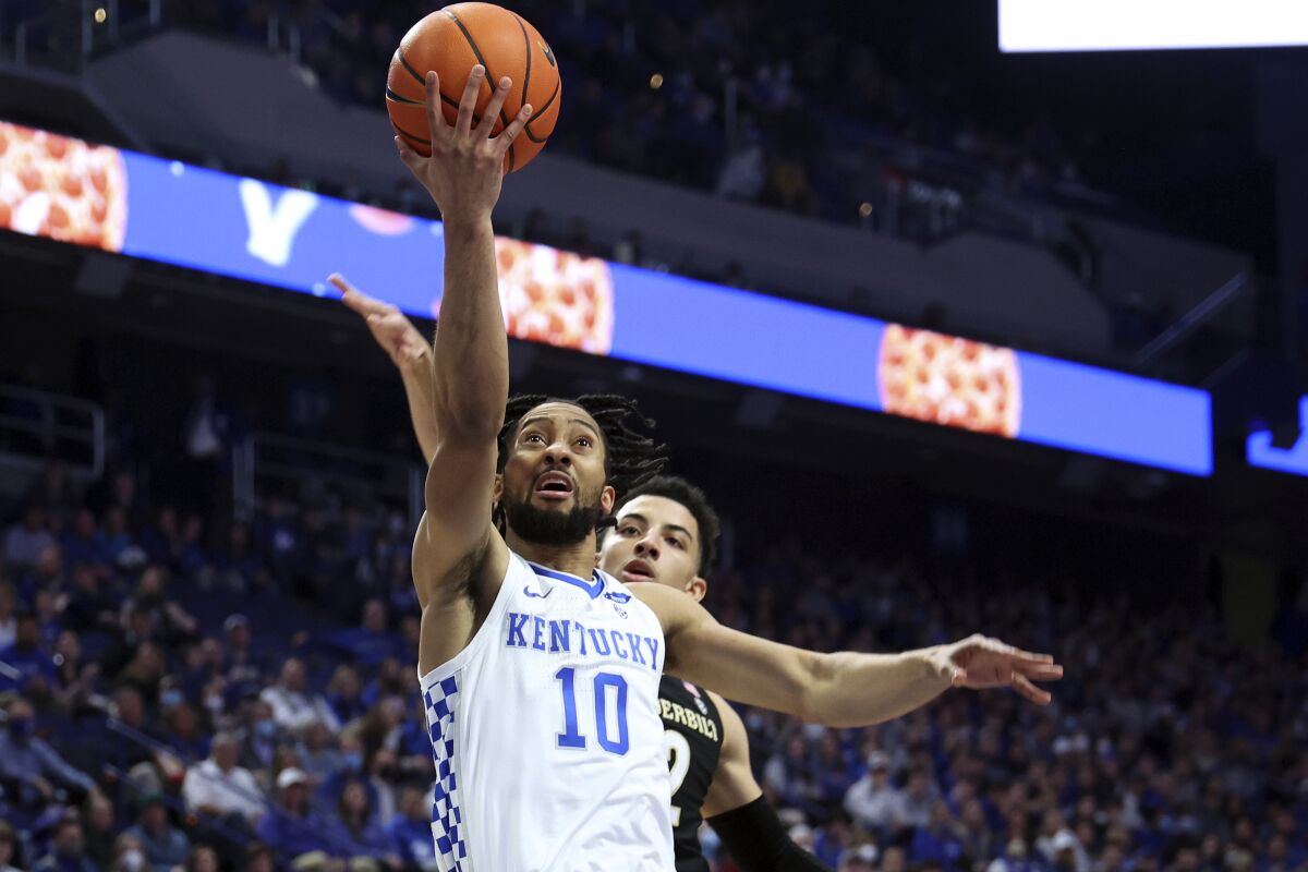 Kentucky's Davion Mintz (10) shoots while defended by Vanderbilt's Scotty Pippen Jr. during the first half of an NCAA college basketball game in Lexington, Ky., Wednesday, Feb. 2, 2022. (AP Photo/James Crisp)