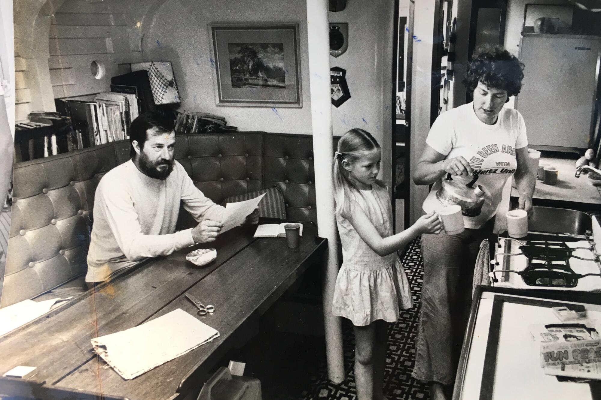 Suzanne with her parents in the main cabin of Wavewalker before leaving England in 1976. 
