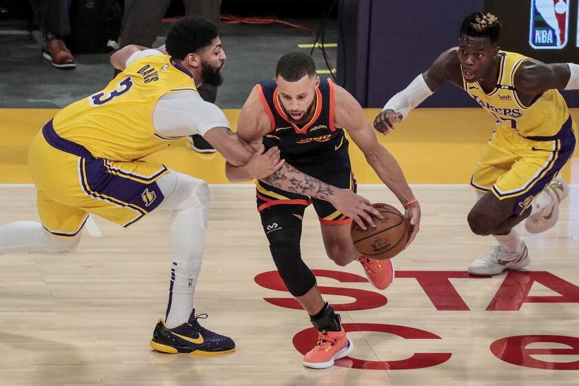 Los Angeles, CA, Wednesday, May 19, 2021 _ Los Angeles Lakers forward Anthony Davis (3) fouls Golden State Warriors guard Stephen Curry (30) during second half action in a Pay-In game at Staples Center. Robert Gauthier/Los Angeles Times)