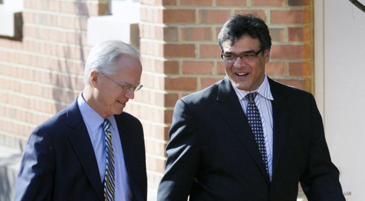 Former CIA officer John Kiriakou, right, and his attorney Robert Trout, walk to U.S. District Court in Alexandria, Va.