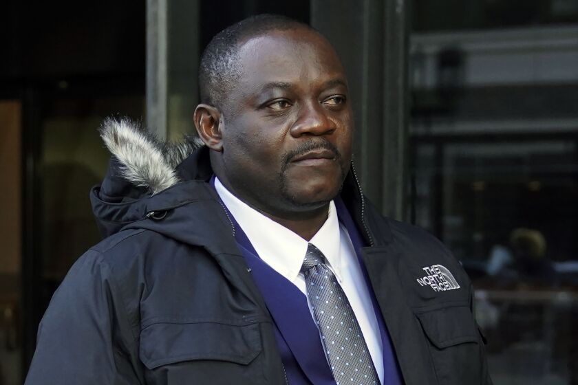 Former Haitian Mayor Jean Morose Viliena departs federal court, Monday, March 20, 2023, in Boston. Viliena, a lawful permanent resident of the U.S. who now lives in Malden, Mass., was sued by three Haitian citizens who say they or their relatives were persecuted by him and his political allies. (AP Photo/Steven Senne)