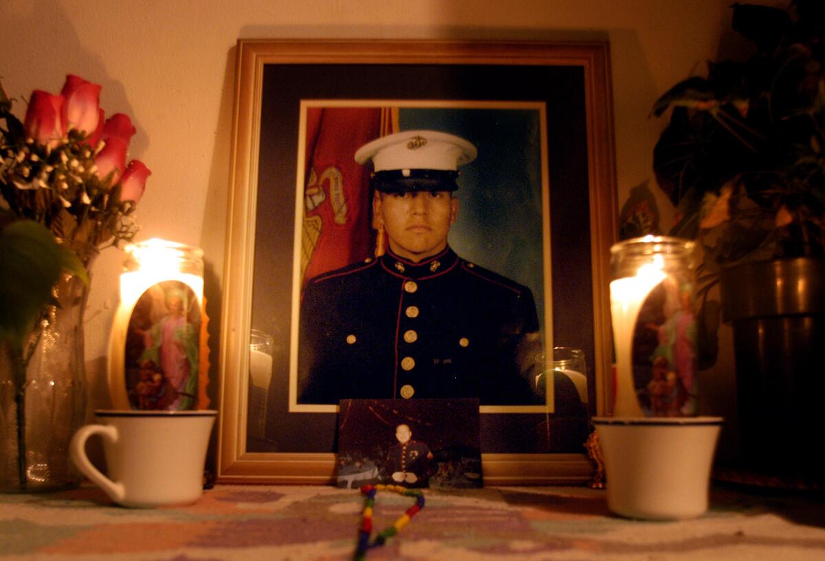 Candles and flowers frame a photos of Jose Angel Garibay in the living room of his mother's Costa Mesa home. (Marc Martin / Los Angeles Times)