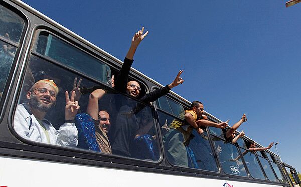 Exultant Palestinians released from Israeli detention acknowledge crowds welcoming their return to the Gaza Strip.