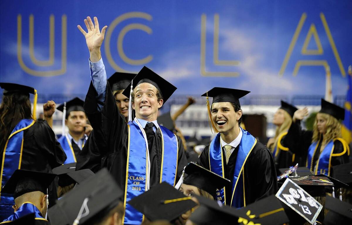Graduates wave to friends and family before the start of the UCLA ceremony. Despite facing one of the worst economies in generations, new college graduates and their peers are optimistic about their futures.