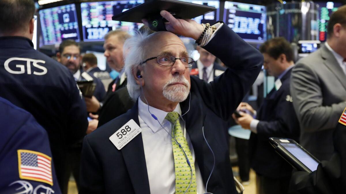 Trader Peter Tuchman works on the floor of the New York Stock Exchange.