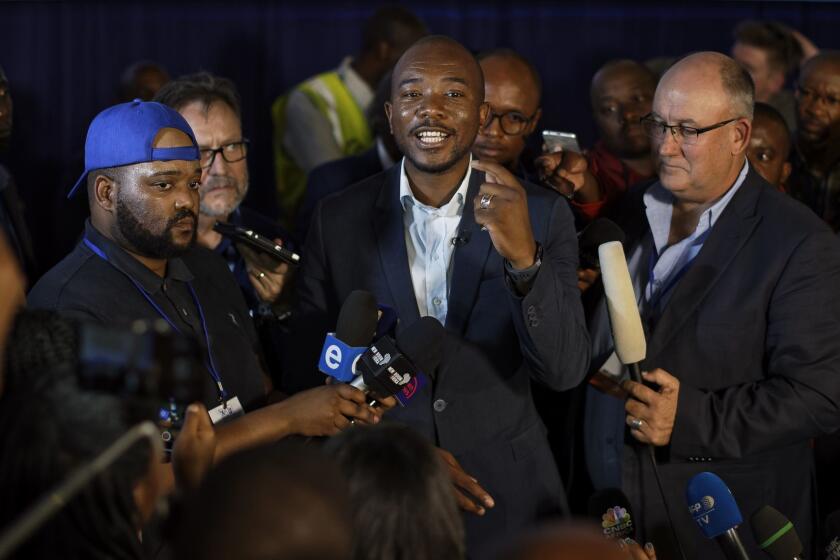 Mmusi Maimane, leader of the largest opposition party, the Democratic Alliance, addresses the media as he visits the Independent Electoral Commission Results Center in Pretoria in Pretoria, South Africa Friday, May 10, 2019. The ruling African National Congress is coasting to a comfortable lead in South Africa's presidential and parliamentary elections with 80% of the vote counted, but the ongoing tally shows the party getting less support than in the previous poll five years ago. (AP Photo/Ben Curtis)