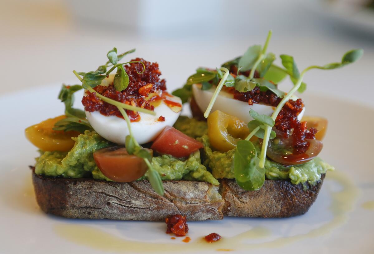 Avocado toast with boiled egg and crunchy garlic sauce at Verdant.