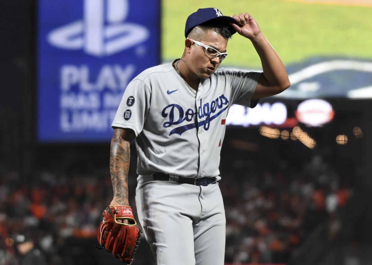 Dodgers starting pitcher Julio Urías walks off the field.