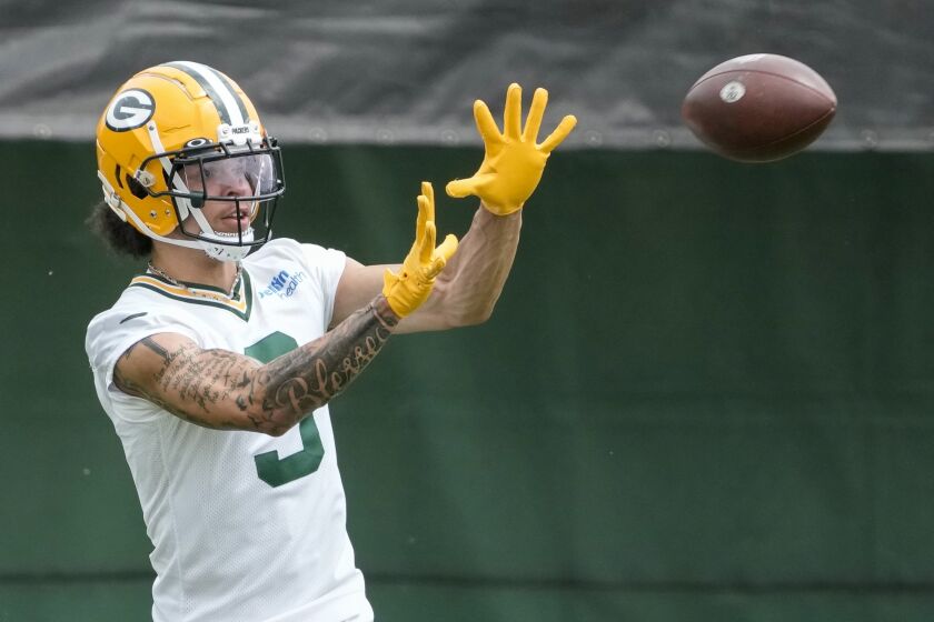 Green Bay Packers' Christian Watson catches a pass during an NFL football OTA practice session Wednesday, May 31, 2023, in Green Bay, Wis. (AP Photo/Morry Gash)