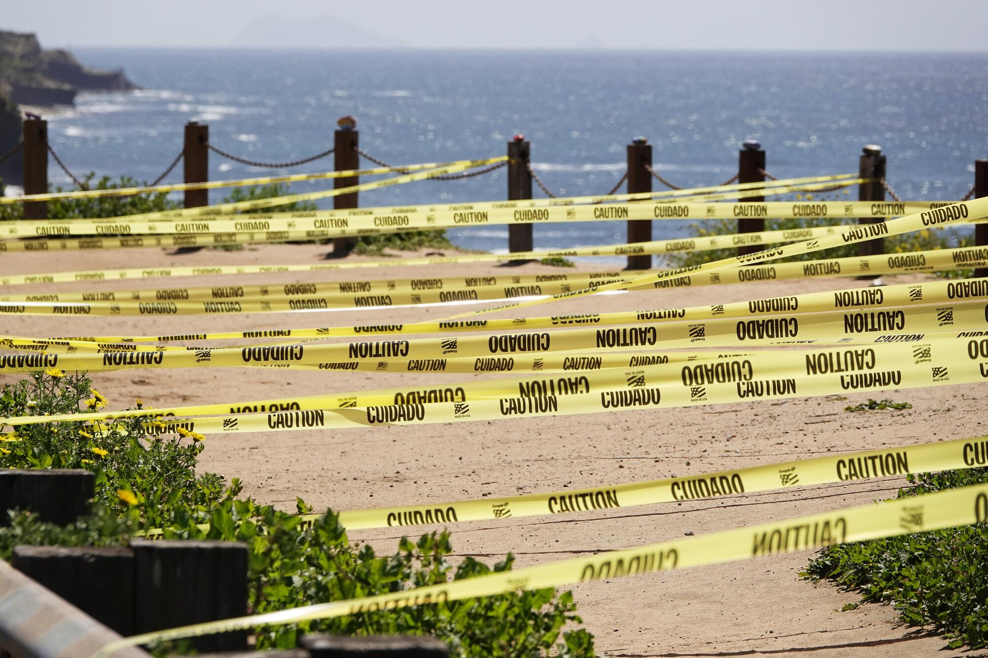 Caution tape is strung across the edge of the Sunset Cliffs in the Point Loma community of San Diego.