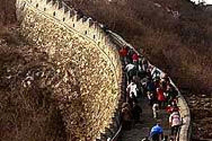 Tourists negotiate a steep section of the Great Wall outside Beijing. In varying states of repair, the landmark runs about 4,000 miles from east to west, across five Chinese provinces.