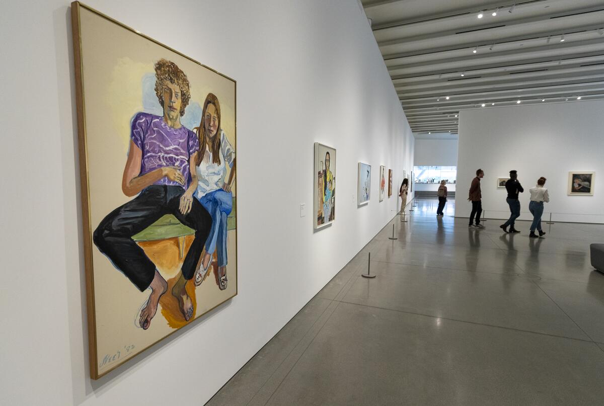Guests look at the exhibit "Feels Like Home" featuring works of the late Alice Neel. 