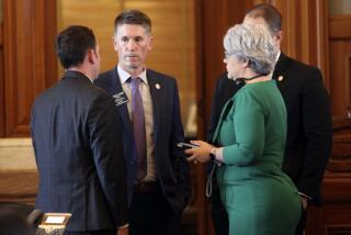 Kansas state Rep. Steve Howe, center, R-Salina, confers with House Speaker Pro Tem Blake Carpenter, left, R-Derby, and Susan Estes, right, R-Wichita, during a debate on a bill that would limit the use of diversity, equity and improvement in admitting students and hiring or promoting on state university campuses, Wednesday, March 20, 2024, at the Statehouse in Topeka, Kan. Republican lawmakers in more than 20 states are pursuing measures to restrict DEI initiatives. (AP Photo/John Hanna)