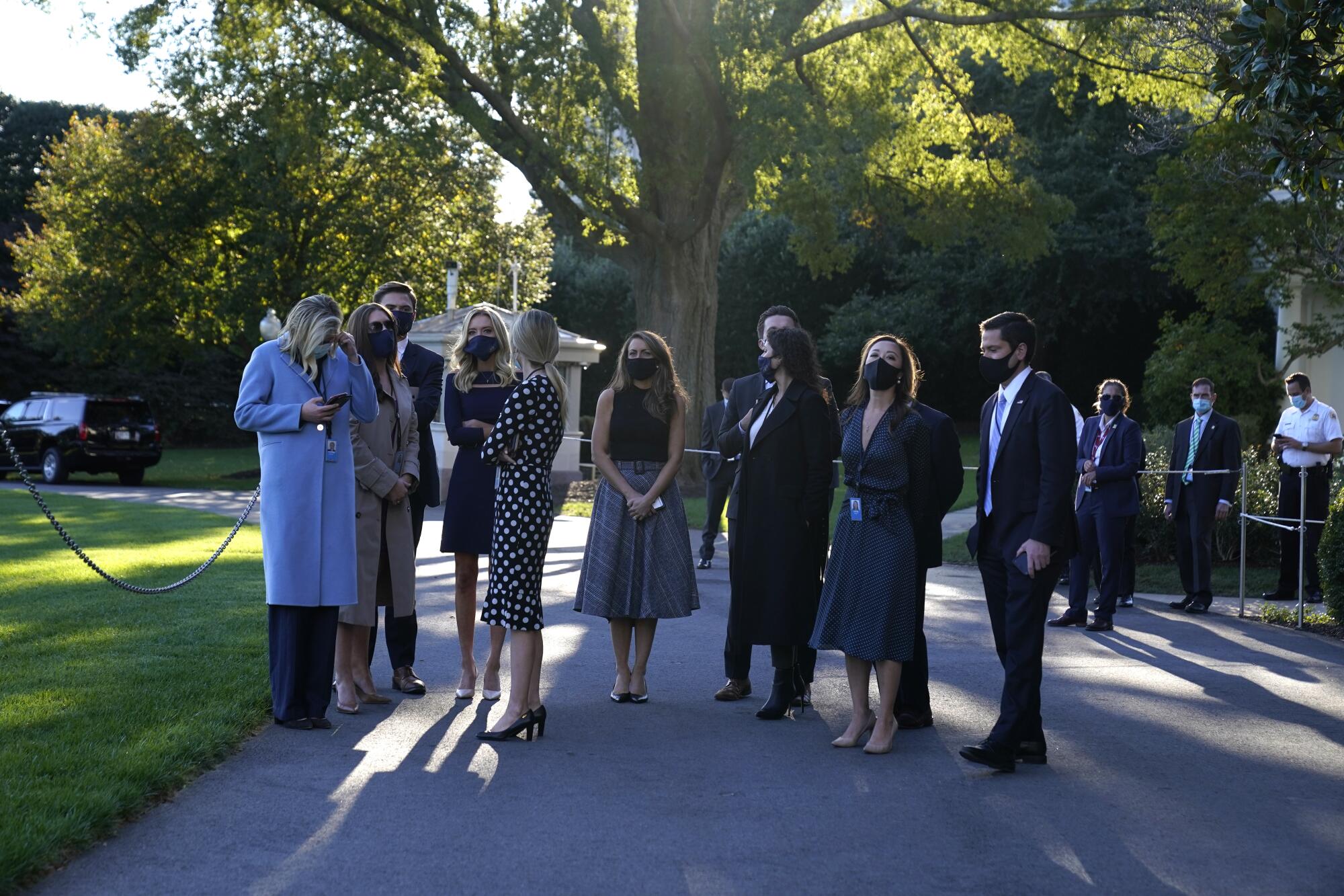 White House press secretary Kayleigh McEnany, fourth from left, waits with others.
