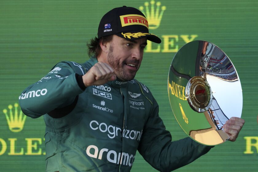 Aston Martin driver Fernando Alonso of Spain celebrates with his trophy after finishing 3rd in the Australian Formula One Grand Prix at Albert Park in Melbourne, Sunday, April 2, 2023. (AP Photo/Asanka Brendon Ratnayake)