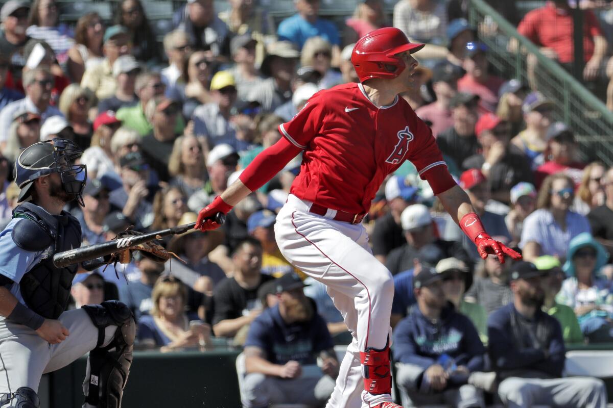 Angels' Jason Castro follows through on an RBI base hit during the second inning of a spring training game against the Seattle Mariners on Wednesday in Tempe, Ariz.