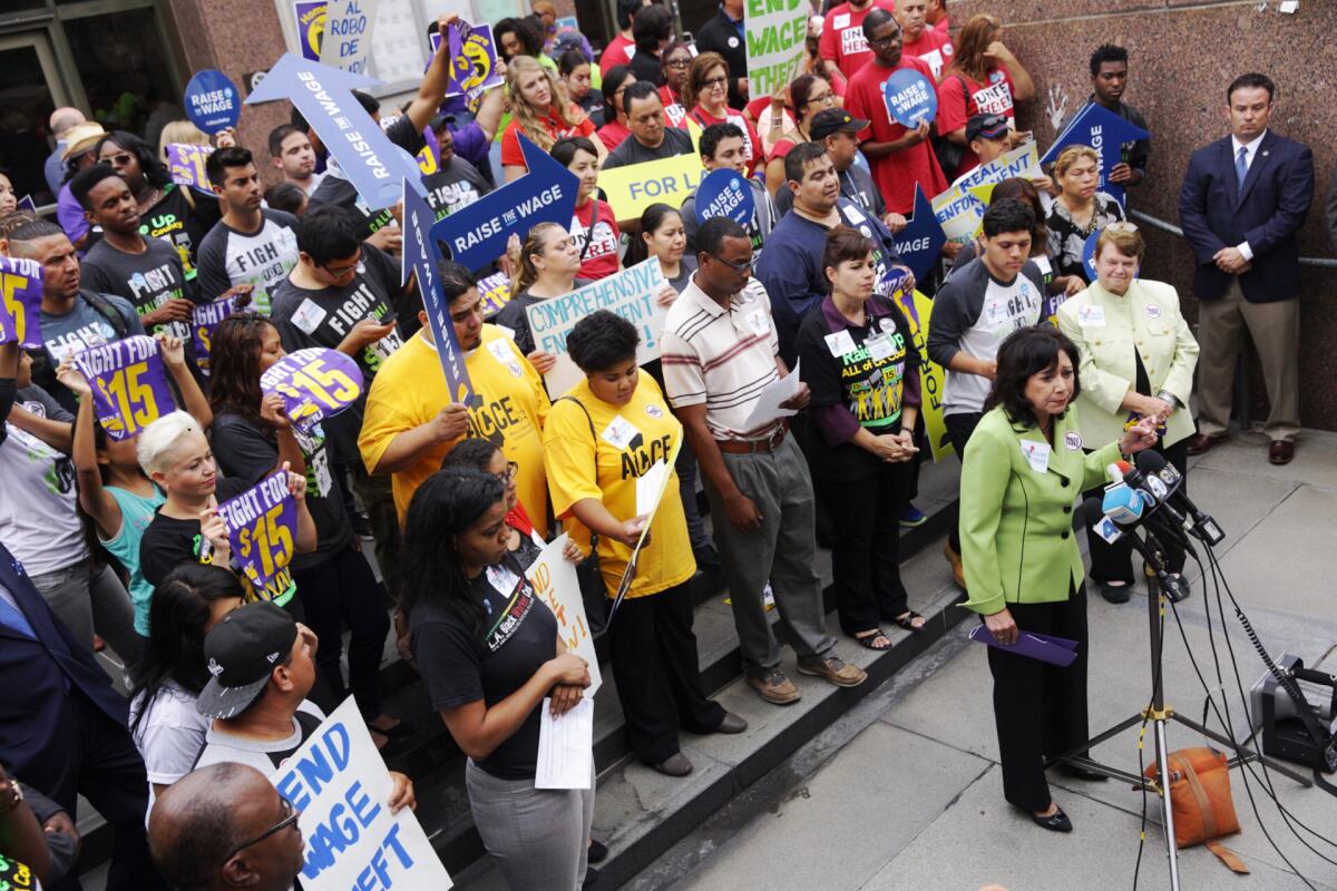 L.A. County supervisor Hilda Solis leads a rally by labor groups to raise the minimum wage to $15 by 2020 in Los Angeles on July 21.