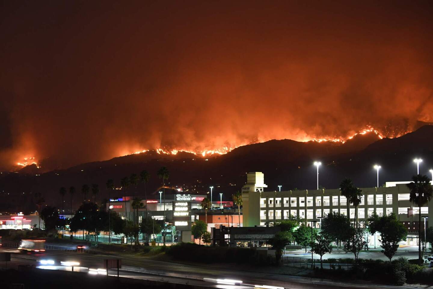The La Tuna fire burns in the hills above Burbank early Saturday.