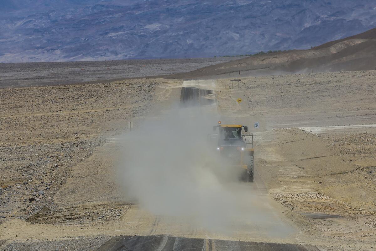 Wind kicks up dust along Badwater Road, where crews continue to clean up damage from Tropical Storm Hilary.