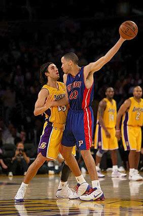 Tayshaun Prince of the Detroit Pistons controls the ball against Sasha Vujacic of the Lakers Friday night.