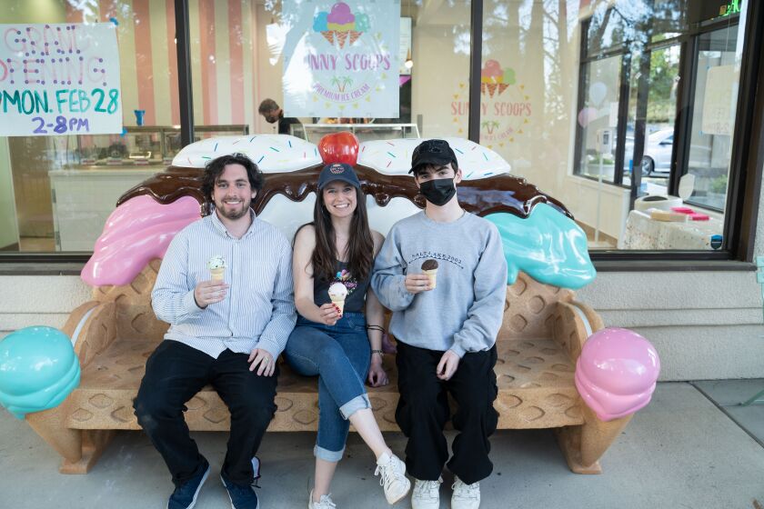 The ice cream bench at Sunny Scoops has become an attraction. From left, Danny Heimler, Stephanie Heimler and Nathan Conlan.
