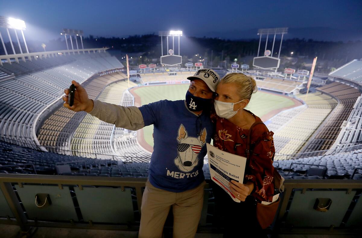 Dodgers fans Erik Solis and his fiancee Patricia Van take a selfie after casting their ballots at Dodger Stadium.