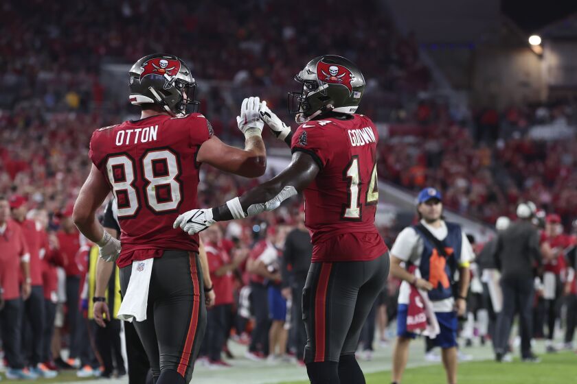 Tampa Bay Buccaneers tight end Cade Otton (88) celebrate his touchdown pass with wide receiver Chris Godwin (14) in the second half of an NFL football game against the New Orleans Saints in Tampa, Fla., Monday, Dec. 5, 2022. (AP Photo/Mark LoMoglio)