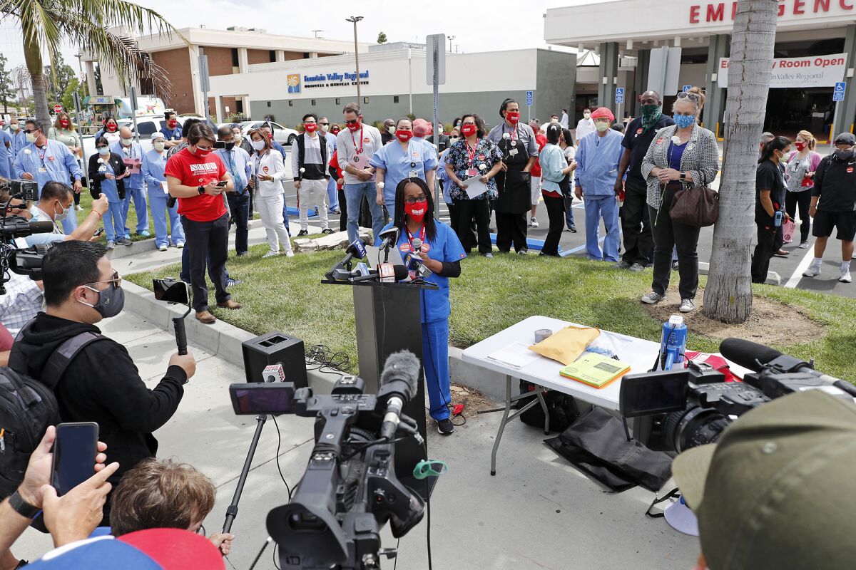 Michelle Riggins, a certified nursing assistant, speaks outside Fountain Valley Regional Hospital's emergency room Thursday.