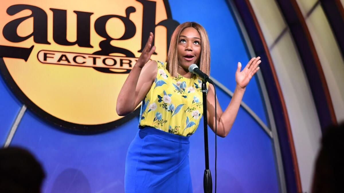 Comic Tiffany Haddish gives advice to one of the aspiring comics at the Laugh Factory in Los Angeles for the club's summer comedy camp for kids, many of whom come from tough situations.